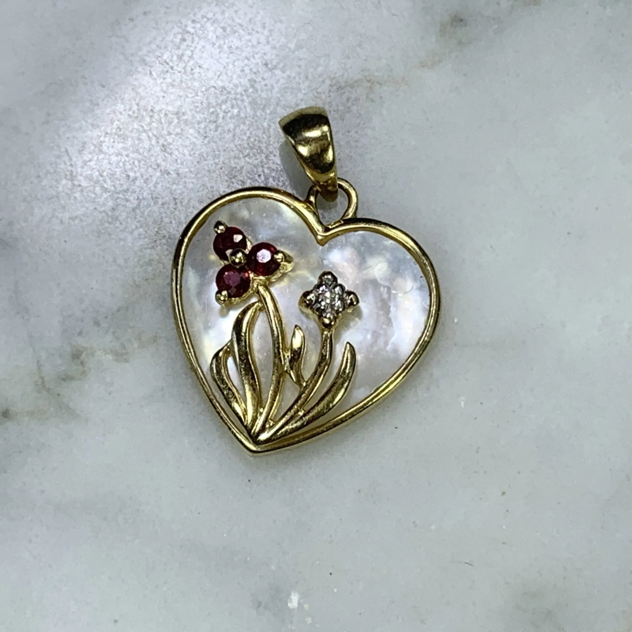 1960s Heart Shaped Mother of Pearl Pendant with Diamond and Ruby Flowers set in 10k Yellow Gold.