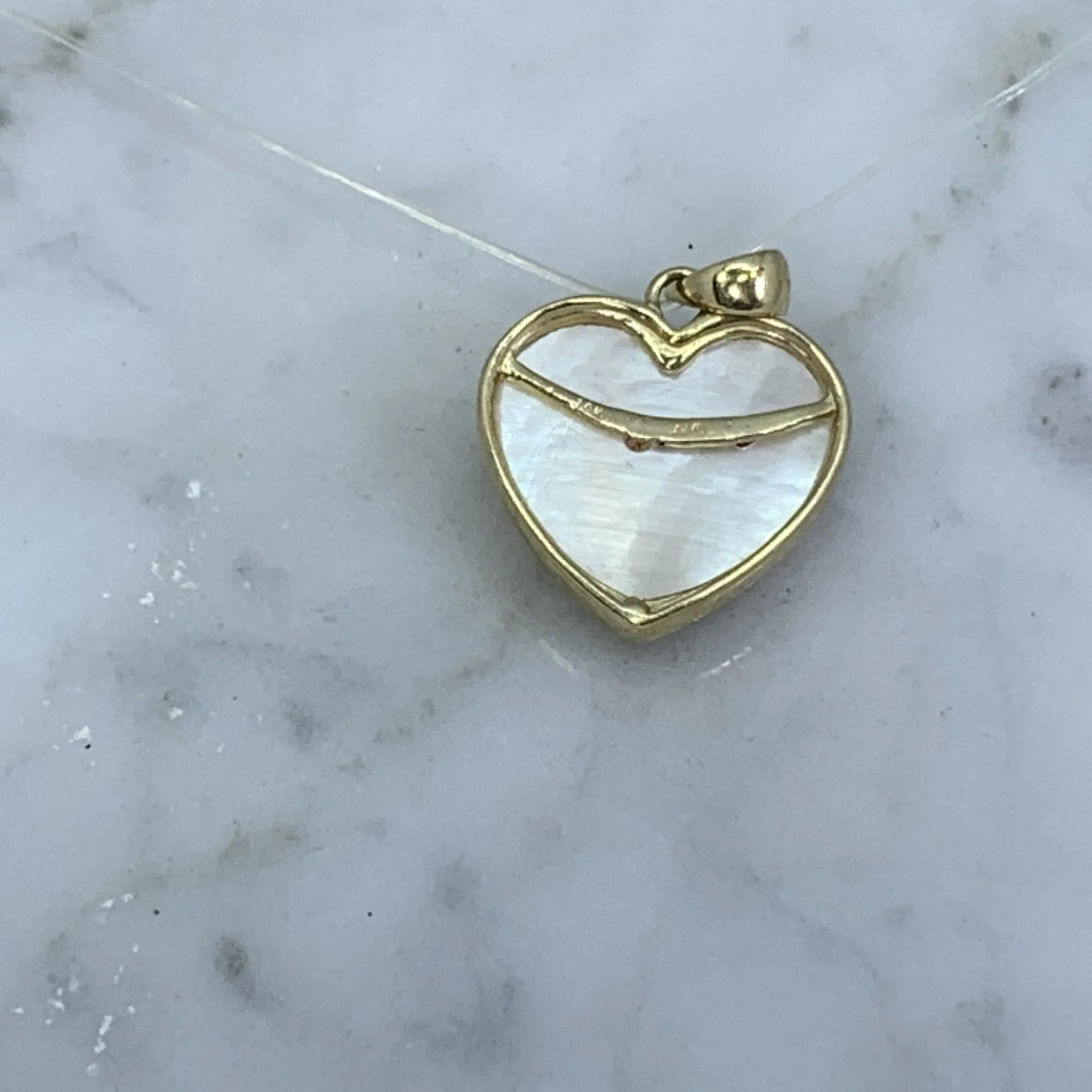 1960s Heart Shaped Mother of Pearl Pendant with Diamond and Ruby Flowers set in 10k Yellow Gold.